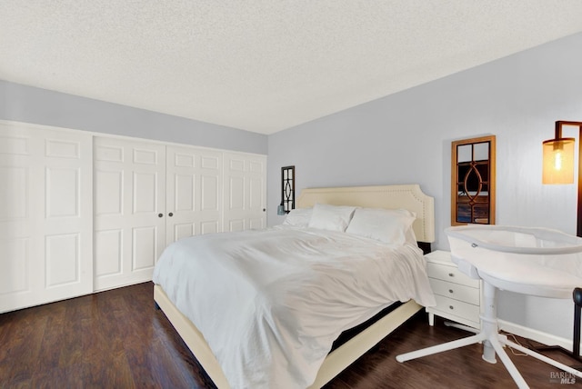 bedroom featuring a closet, dark hardwood / wood-style flooring, and a textured ceiling