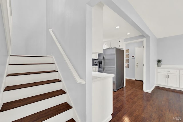 staircase with hardwood / wood-style flooring