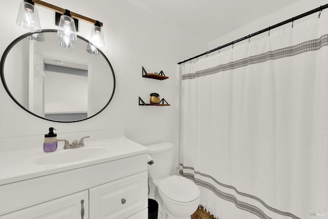 bathroom featuring toilet and vanity