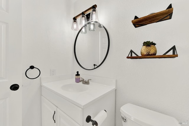 bathroom featuring toilet and vanity