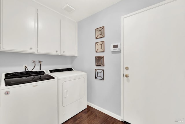 washroom with washer and clothes dryer, dark hardwood / wood-style flooring, and cabinets