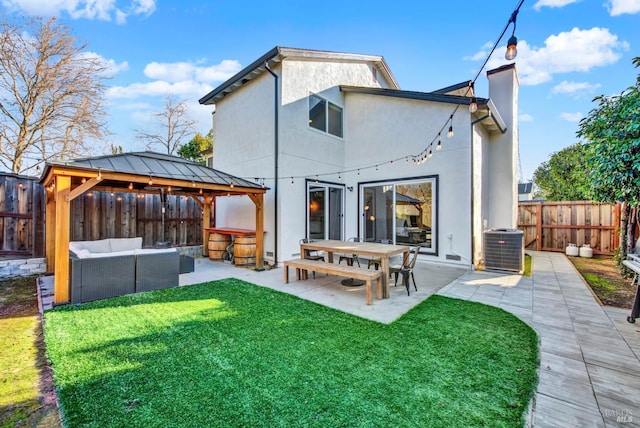 rear view of house featuring a patio area, a gazebo, outdoor lounge area, and a yard