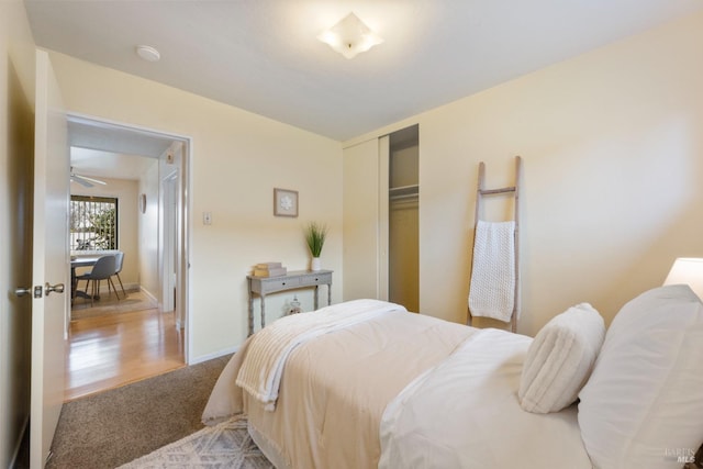 bedroom with light colored carpet and a closet