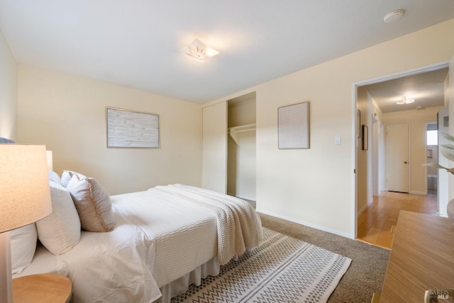 bedroom featuring light hardwood / wood-style floors and a closet