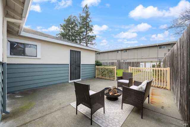 view of patio / terrace with an outdoor living space with a fire pit