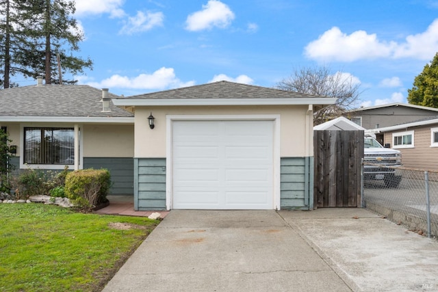 single story home featuring a garage and a front yard