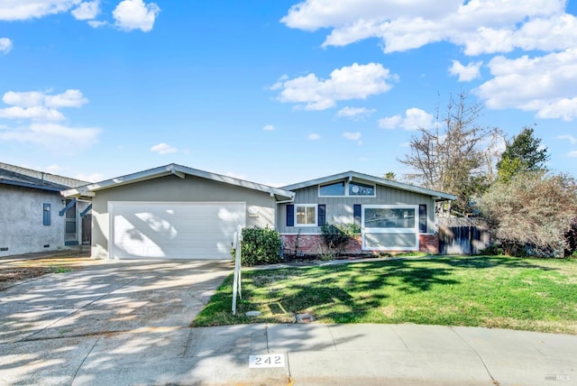 ranch-style house featuring a garage and a front yard