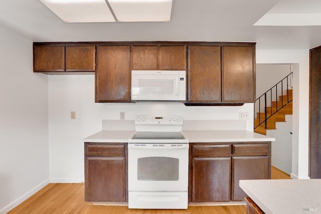 kitchen featuring white appliances and light hardwood / wood-style floors