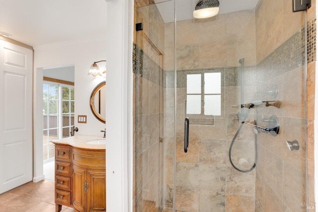 bathroom with an enclosed shower, vanity, tile patterned flooring, and ornamental molding