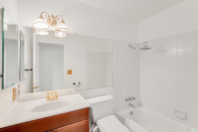 full bathroom with vanity, tiled shower / bath combo, and toilet