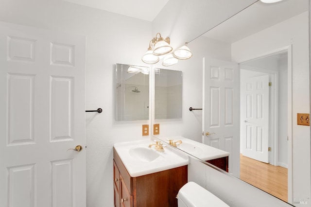 bathroom with hardwood / wood-style flooring and vanity