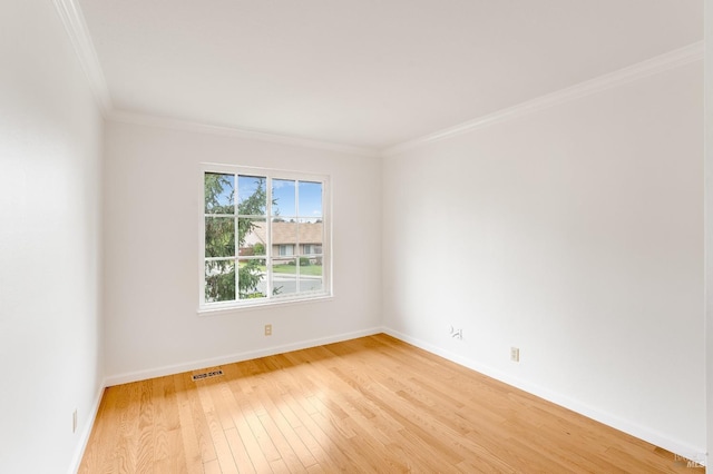 unfurnished room with crown molding and light wood-type flooring