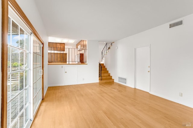 unfurnished living room featuring light hardwood / wood-style flooring