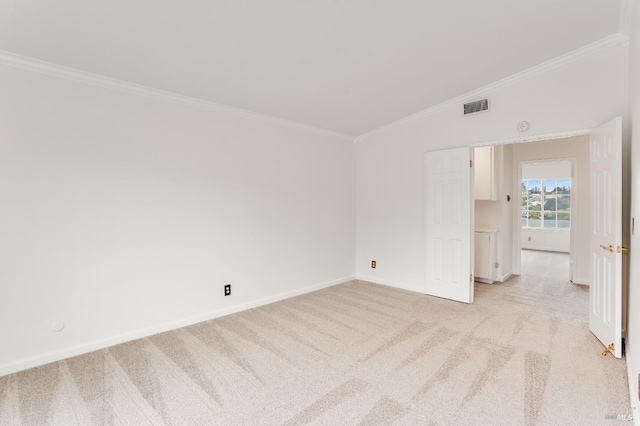 carpeted spare room with ornamental molding and vaulted ceiling