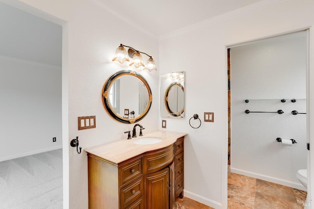 bathroom with crown molding, vanity, and toilet