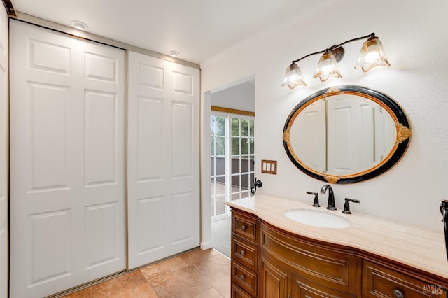 bathroom featuring tile patterned flooring, vanity, and crown molding