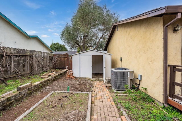 view of yard with cooling unit and a storage shed