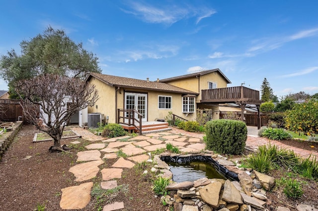 rear view of house featuring a patio, central AC, french doors, and a deck