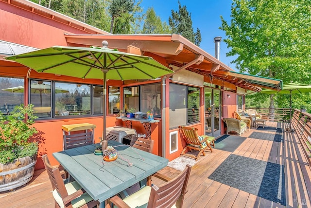 wooden terrace featuring outdoor dining space