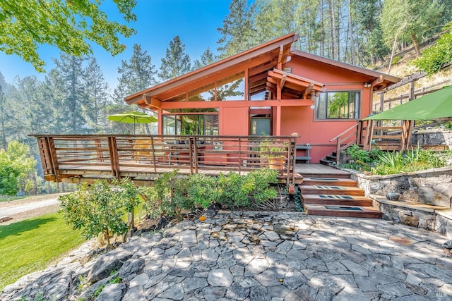 exterior space with a wooden deck and a patio area