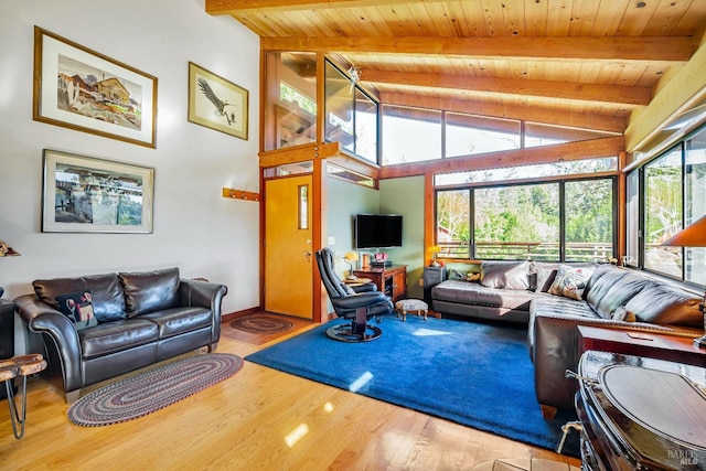 living area featuring beamed ceiling, wood finished floors, high vaulted ceiling, and wooden ceiling