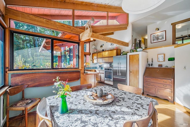 dining area with wooden ceiling and vaulted ceiling with beams