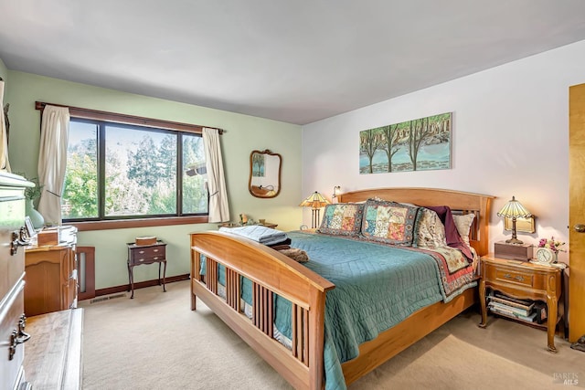 bedroom featuring light carpet