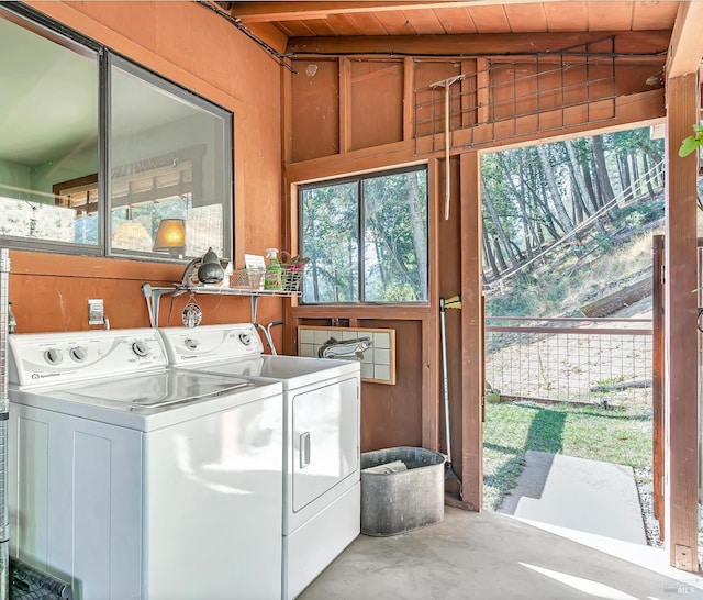 laundry room with wood ceiling, independent washer and dryer, and laundry area