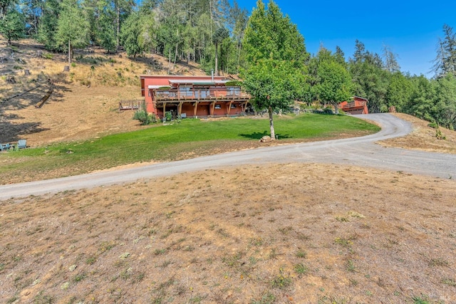 view of front of house featuring a front lawn and a deck