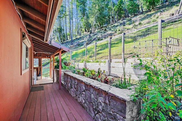 deck featuring a rural view and fence