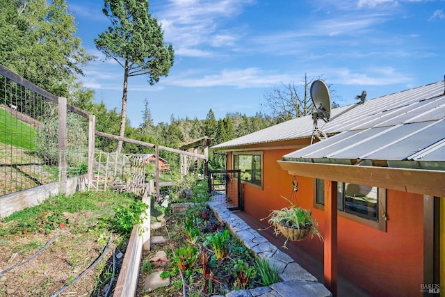 view of yard with a vegetable garden and fence