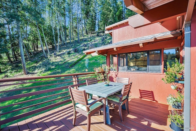 deck with outdoor dining area