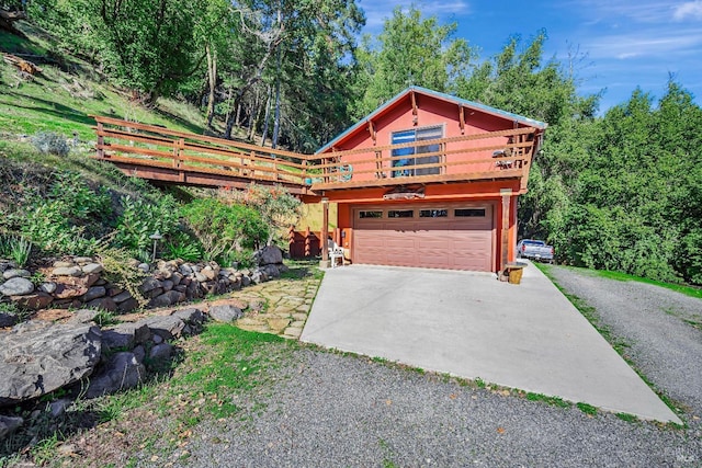 view of front of home featuring a wooden deck and a garage