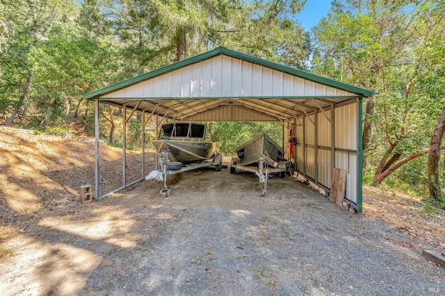 view of car parking with a detached carport and driveway