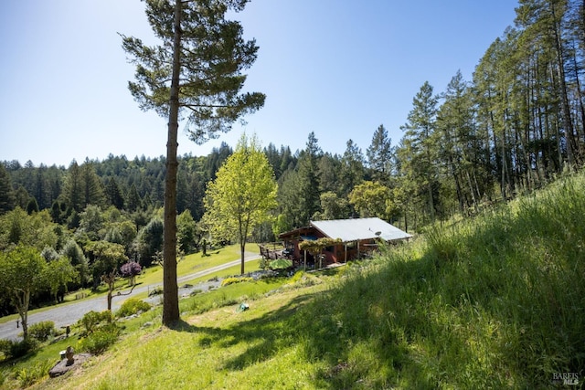 exterior space with a wooded view