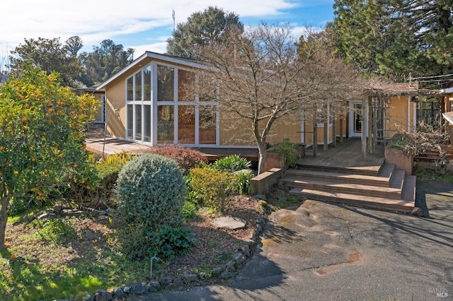 view of front of property featuring a wooden deck and a sunroom