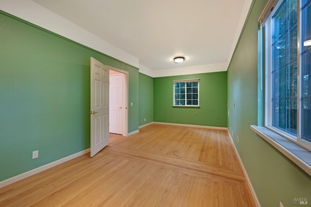 unfurnished room with light hardwood / wood-style floors