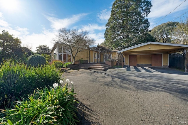 view of front of house featuring a carport and a garage