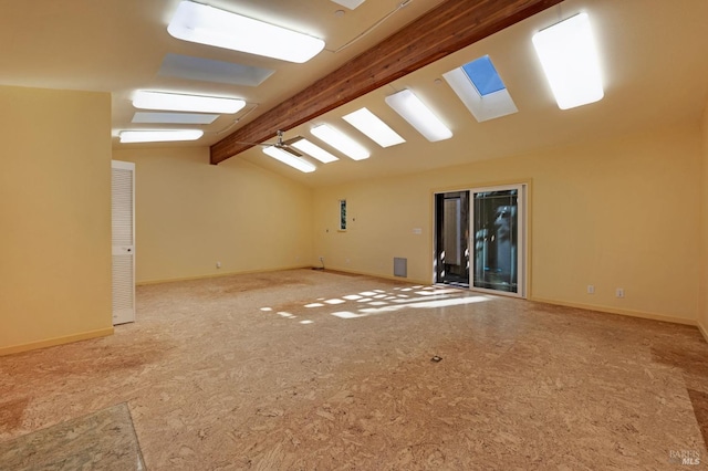 empty room with vaulted ceiling with beams