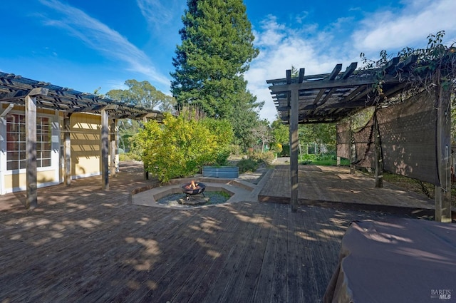 view of patio / terrace featuring a wooden deck, a fire pit, and a pergola