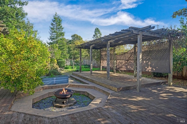 view of patio with an outdoor fire pit, a pergola, and a deck