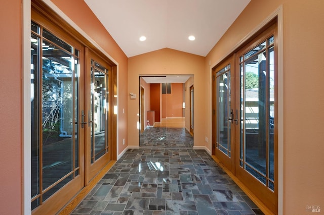 hallway featuring vaulted ceiling and french doors