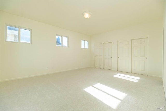 basement with light colored carpet and plenty of natural light