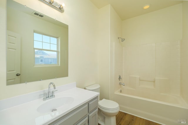 full bathroom featuring toilet, vanity, shower / tub combination, and hardwood / wood-style flooring