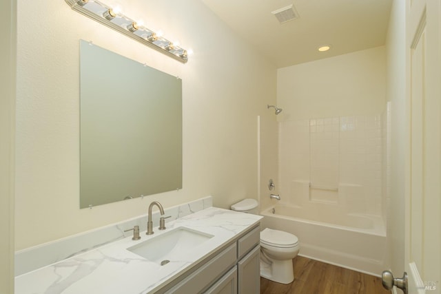 full bathroom featuring toilet, wood-type flooring, shower / washtub combination, and vanity