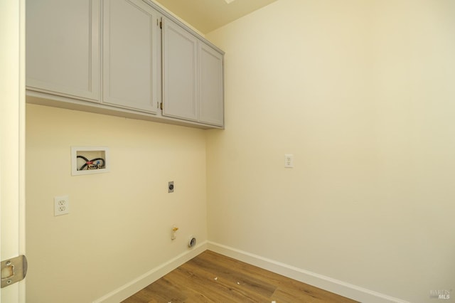 laundry room with washer hookup, cabinets, hardwood / wood-style floors, and electric dryer hookup