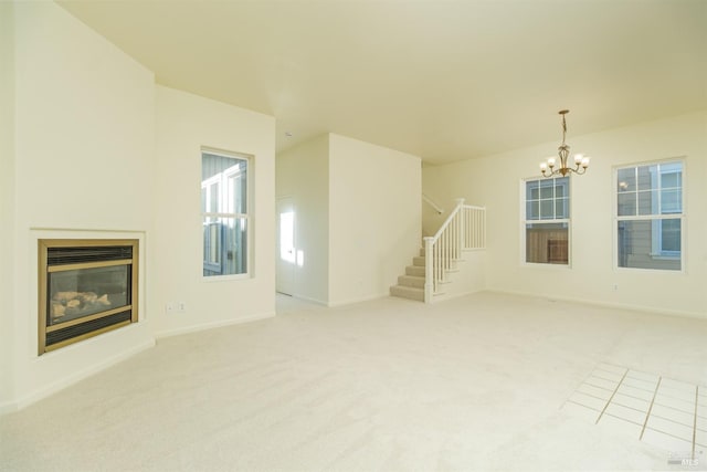 unfurnished living room with carpet and a notable chandelier