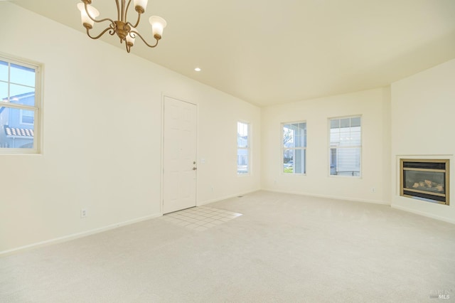 unfurnished living room with light carpet and a chandelier