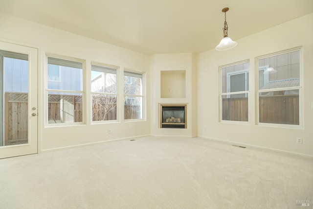 unfurnished living room featuring carpet flooring