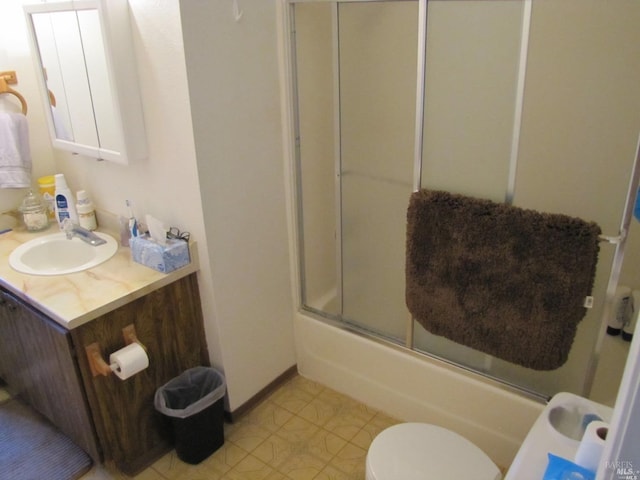 full bathroom featuring vanity, toilet, and combined bath / shower with glass door